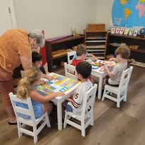 Children working together around a classroom table