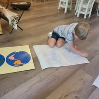 Primary child working with Montessori geography materials